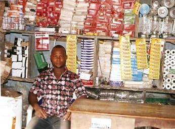 Empowered beneficiary of a small-scale retail business at a village square.
