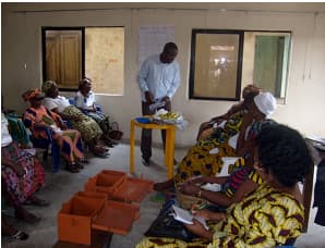 Associate Savings and Credit Associations (ASCAs) members during a meeting session.